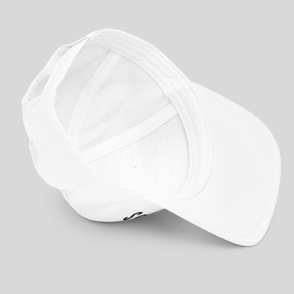 A plain white baseball cap shown from an angled top-down view on a neutral light gray background.