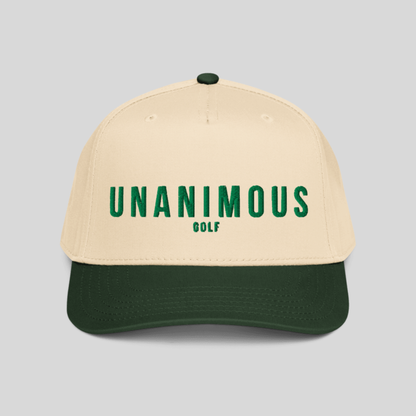 A structured baseball cap with a cream-colored crown and a dark forest green visor, featuring the text 'UNANIMOUS GOLF' embroidered in green on the front. The cap is photographed against a solid light gray background.