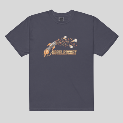 A Navy comfort colors 1717 crewneck t-shirt featuring a graphic of a rocket launching with sparks and the text 'NOSEL ROCKET' printed on the chest, displayed against a solid light gray background.
