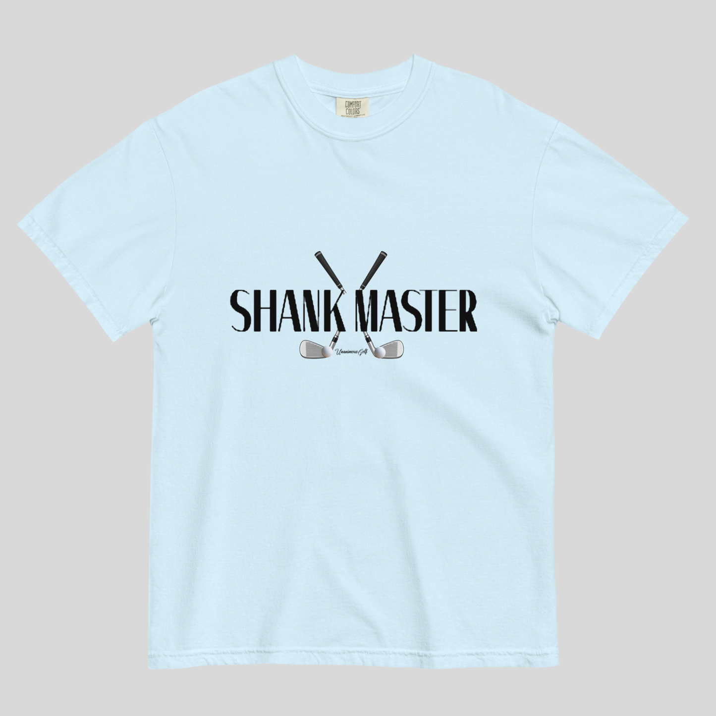 A light blue short-sleeve crewneck t-shirt with a black graphic on the chest reading 'SHANK MASTER' above and below crossed golf clubs, displayed flat against a neutral gray background.