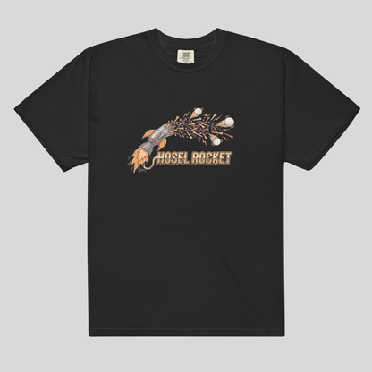 A black short-sleeve comfort colors 1717 crewneck t-shirt featuring a graphic of a rocket launching with the text 'HOSEL ROCKET' printed below it, displayed against a solid light gray background.