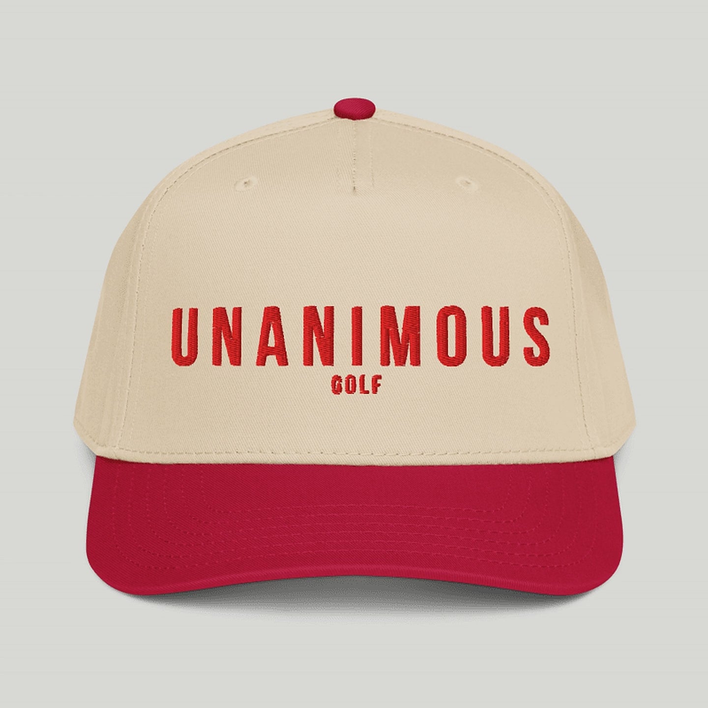 'UNANIMOUS GOLF' embroidered in white across the front, shown against a solid light gray background.