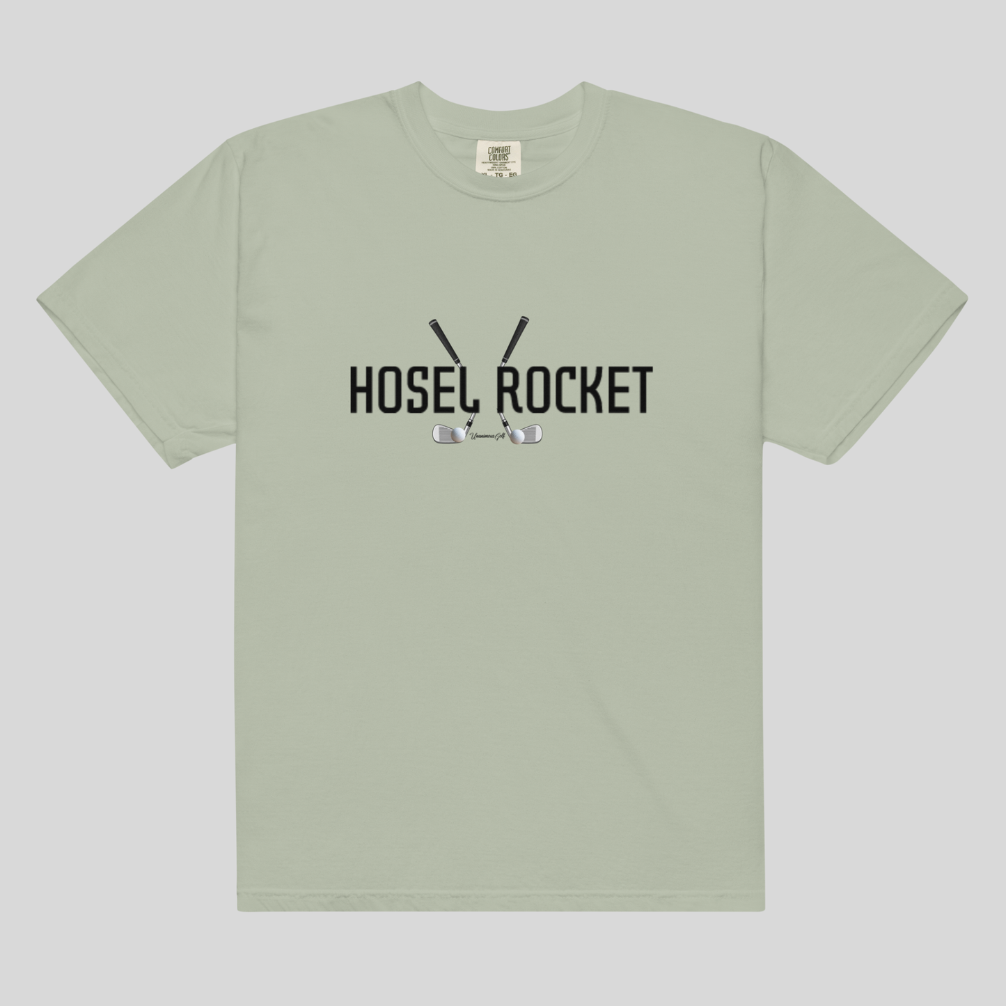 A sage green short-sleeve t-shirt with a black graphic on the chest reading 'HOSEL ROCKET' with golf clubs and balls, displayed flat against a light gray background.