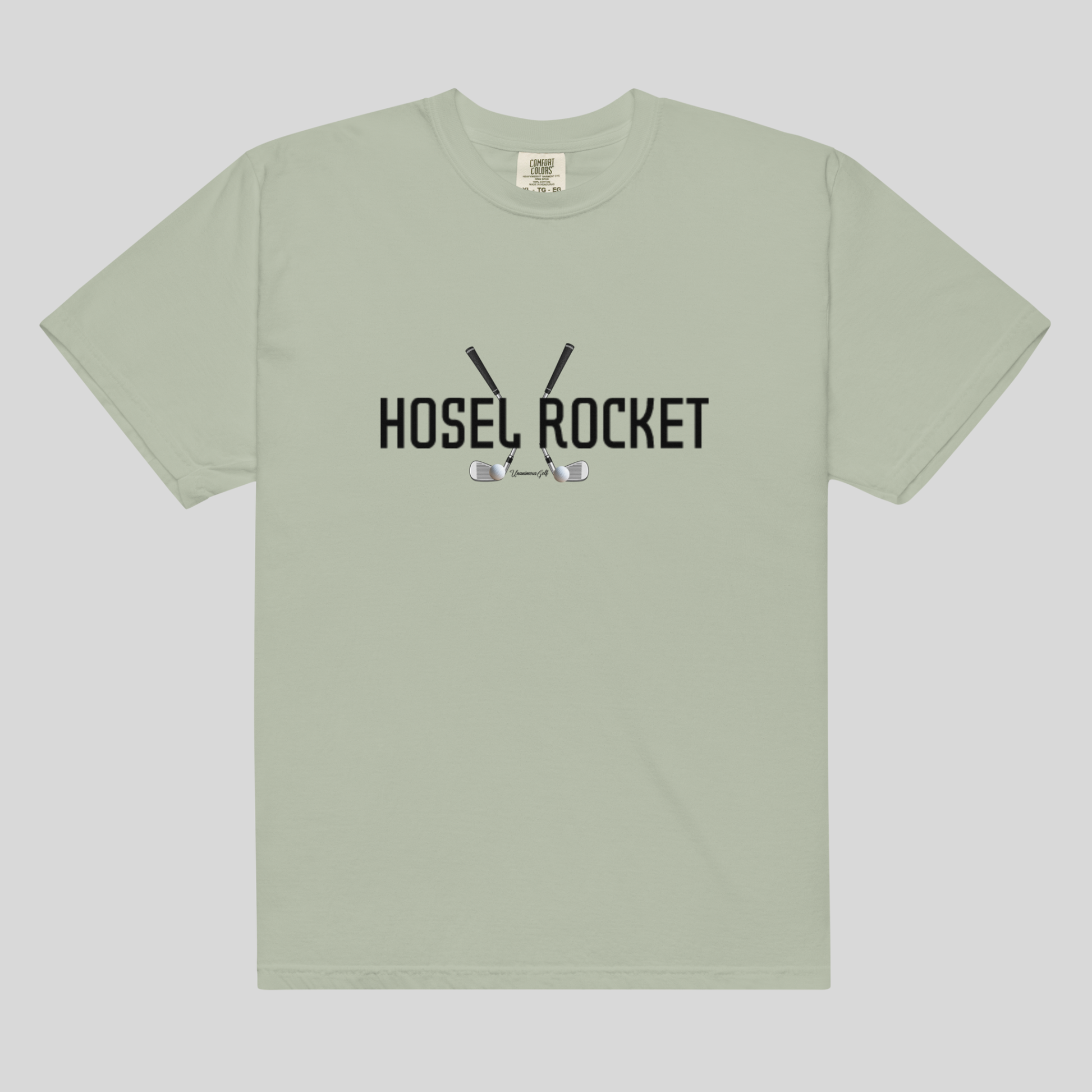 A sage green short-sleeve t-shirt with a black graphic on the chest reading 'HOSEL ROCKET' with golf clubs and balls, displayed flat against a light gray background.