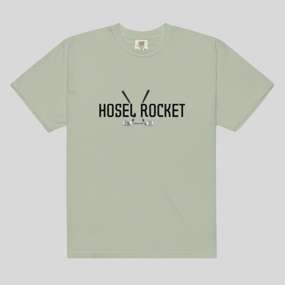 A sage green short-sleeve t-shirt with a black graphic on the chest reading 'HOSEL ROCKET' with golf clubs and balls, displayed flat against a light gray background.